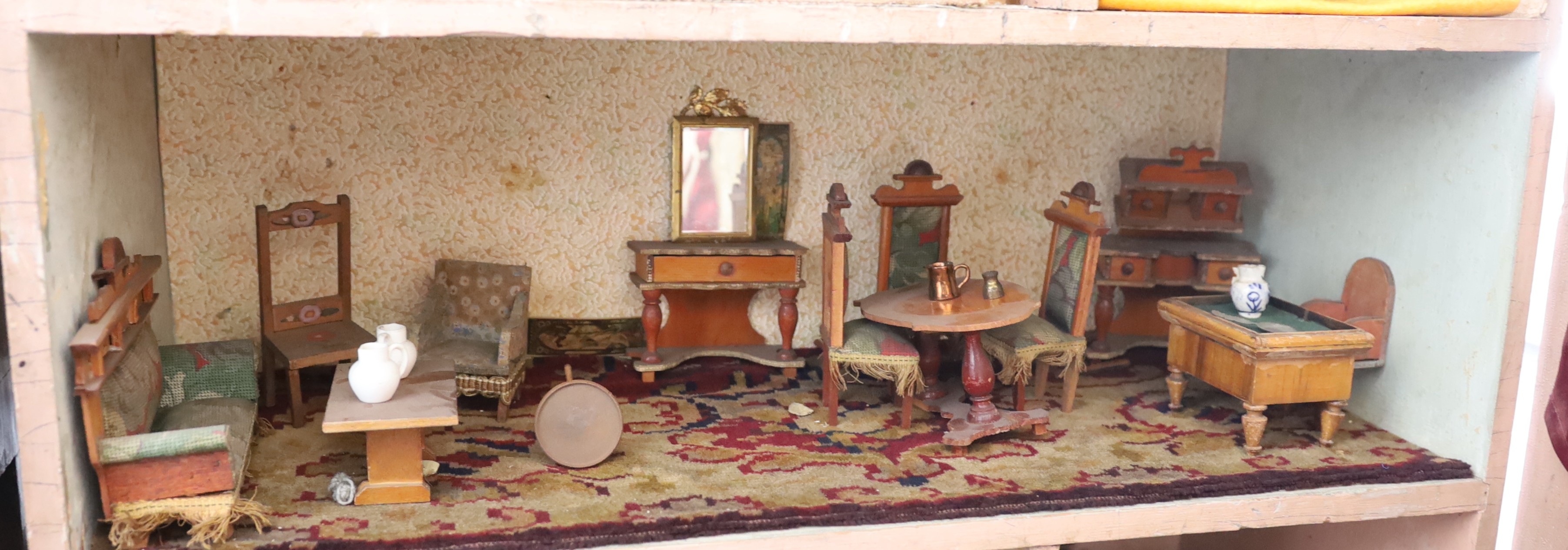 A Victorian furnished dolls’ house, circa 1890, 77cm high.